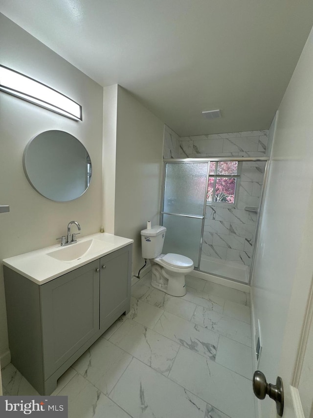 bathroom with vanity, toilet, and an enclosed shower