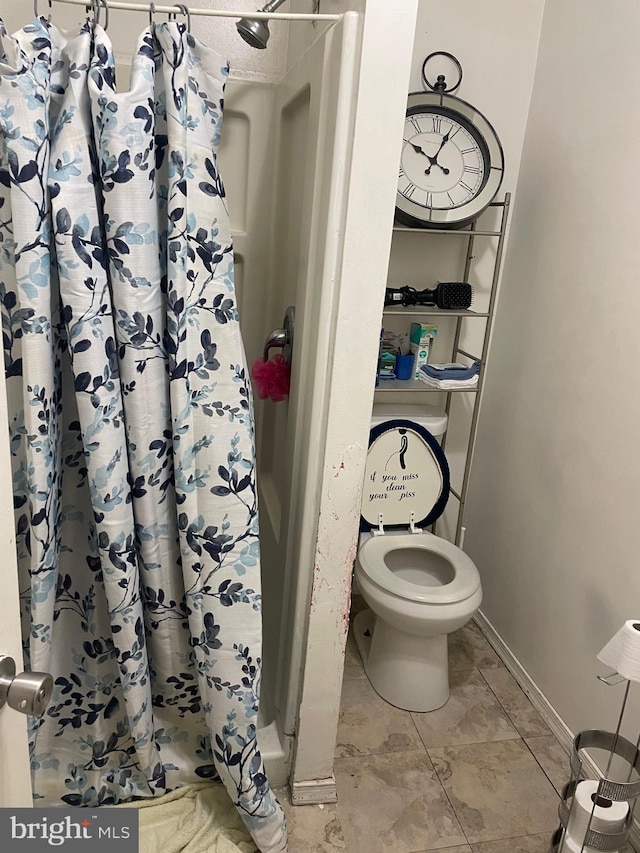 bathroom with toilet and walk in shower