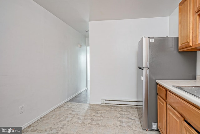 2544 N 25th St, Philadelphia, PA 19132 - kitchen featuring a baseboard radiator, light countertops, freestanding refrigerator, and baseboards