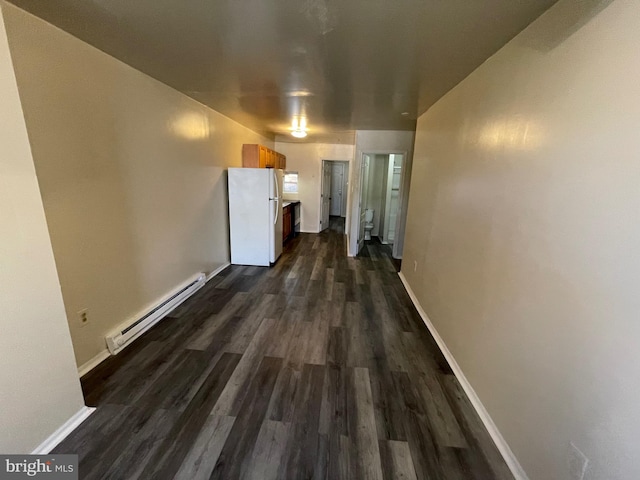 corridor with a baseboard radiator and dark hardwood / wood-style floors