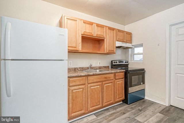2544 N 25th St, Philadelphia, PA 19132 - kitchen with freestanding refrigerator, range with electric stovetop, a sink, under cabinet range hood, and light wood-type flooring