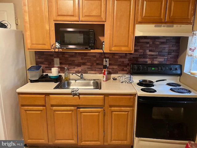 kitchen featuring decorative backsplash, sink, and appliances with stainless steel finishes