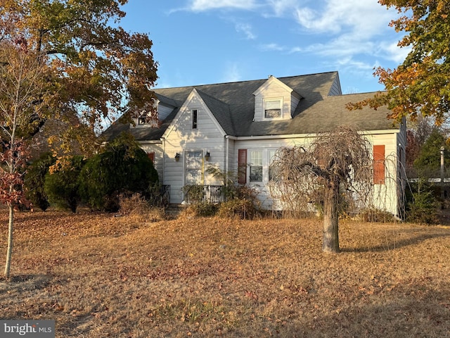 view of side of property with a shingled roof