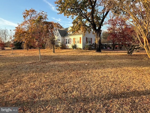 obstructed view of property with a front lawn