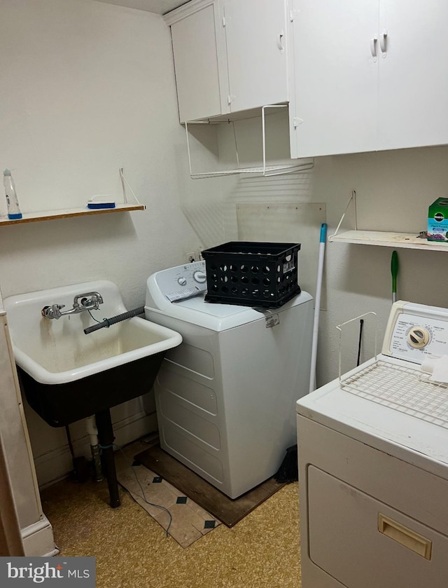 laundry area with washer and clothes dryer and cabinet space