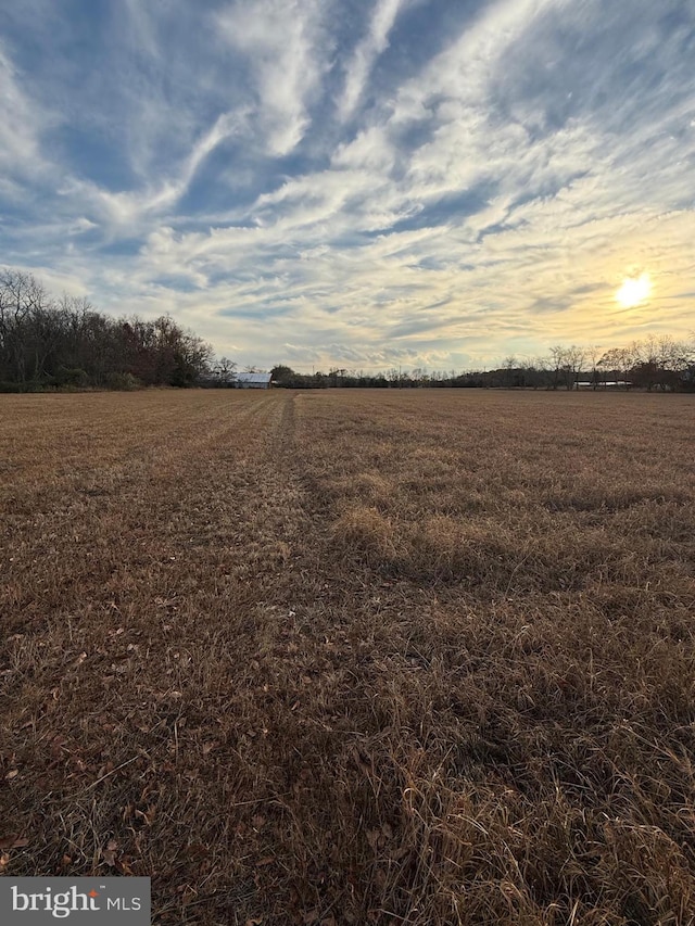 nature at dusk featuring a rural view