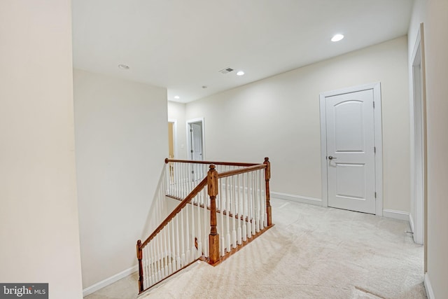 corridor with light colored carpet