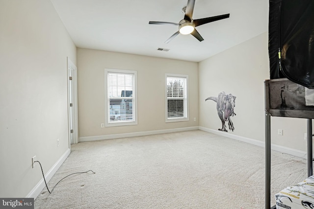 interior space with ceiling fan and light colored carpet