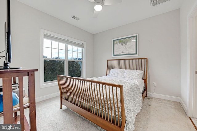 bedroom with ceiling fan and light carpet