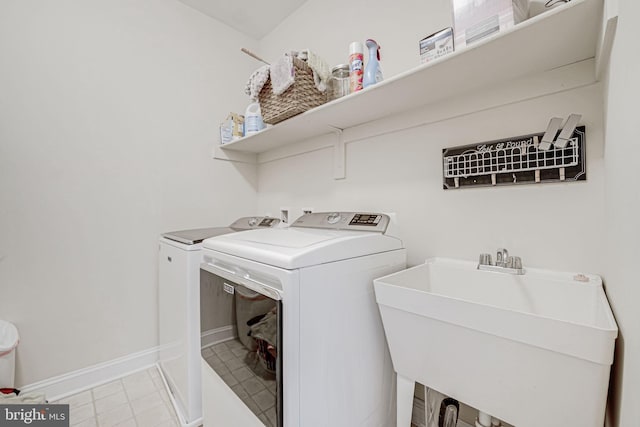 2216 Turnbuckle Ln, Woodbridge, VA 22191 - laundry room with washing machine and dryer, baseboards, and light tile patterned floors