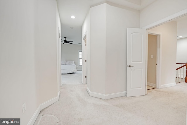 hallway featuring light carpet