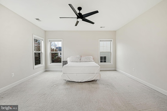 bedroom featuring ceiling fan and light colored carpet