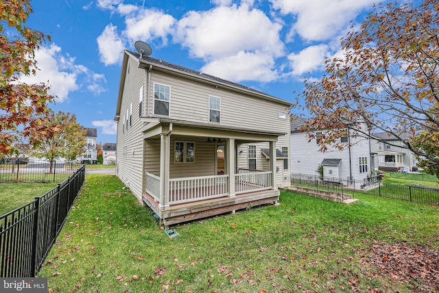 back of house featuring a yard and a deck