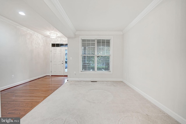 foyer featuring wood-type flooring and crown molding