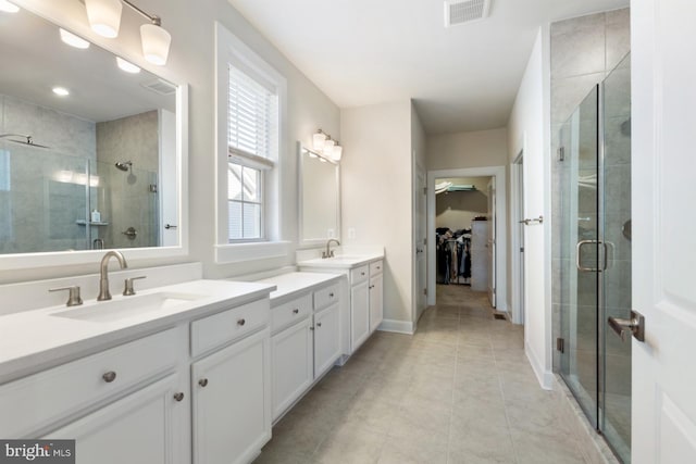 bathroom with vanity, tile patterned floors, and a shower with door