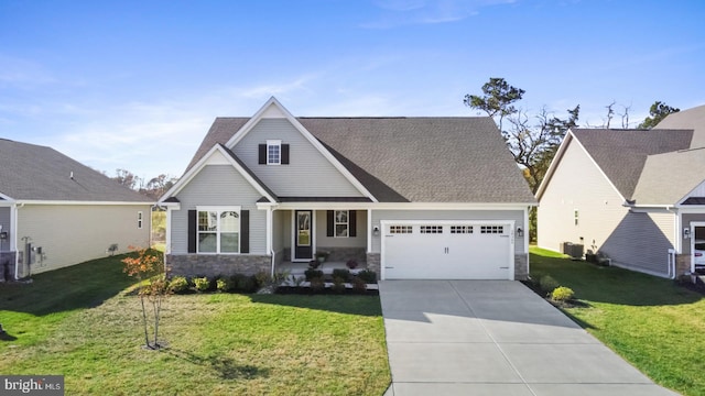 view of front of property with a garage, central AC unit, and a front yard