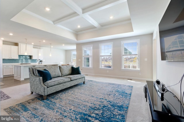 carpeted living room featuring coffered ceiling, beam ceiling, and crown molding