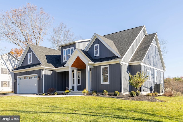 view of front facade featuring central AC, a garage, and a front lawn