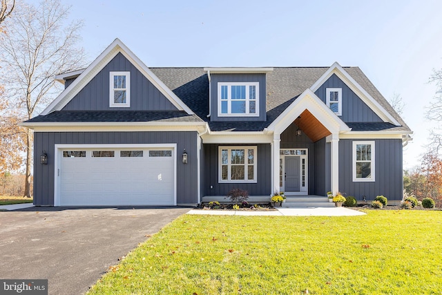 view of front of property with a garage and a front lawn