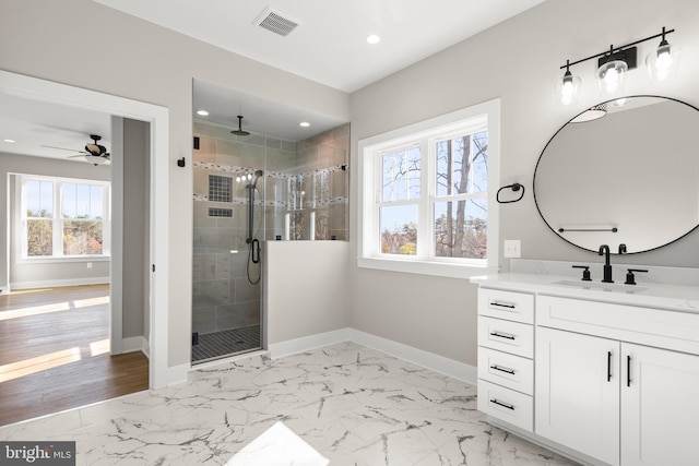 bathroom featuring walk in shower, vanity, and ceiling fan