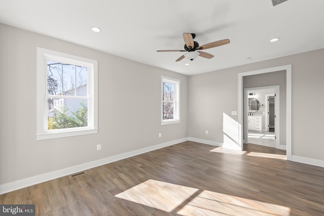 unfurnished room with ceiling fan and dark hardwood / wood-style flooring