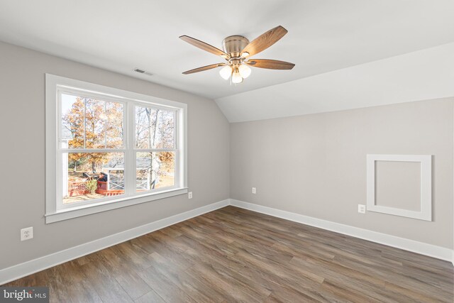 bonus room with ceiling fan, dark hardwood / wood-style flooring, and vaulted ceiling