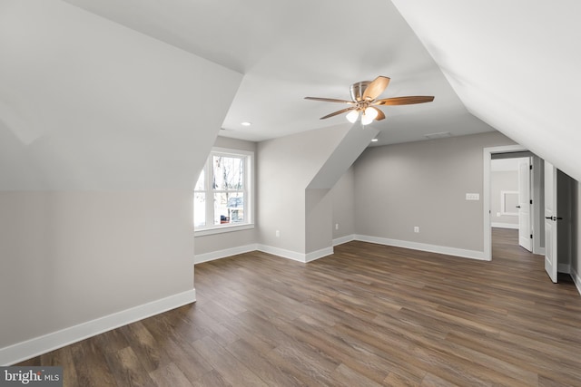 bonus room featuring dark hardwood / wood-style flooring, vaulted ceiling, and ceiling fan