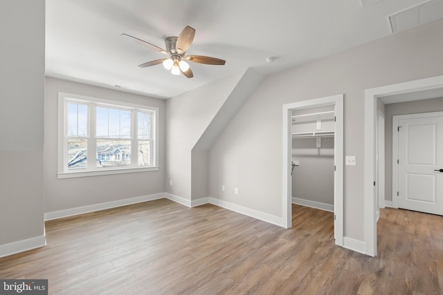 bonus room with ceiling fan and light hardwood / wood-style floors