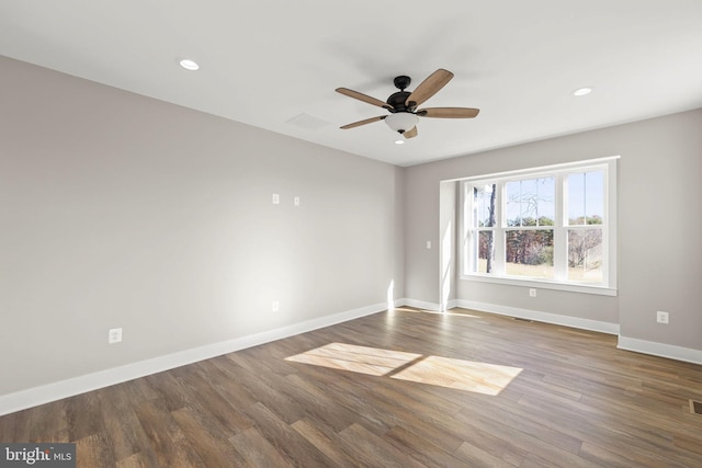 spare room with dark hardwood / wood-style floors and ceiling fan