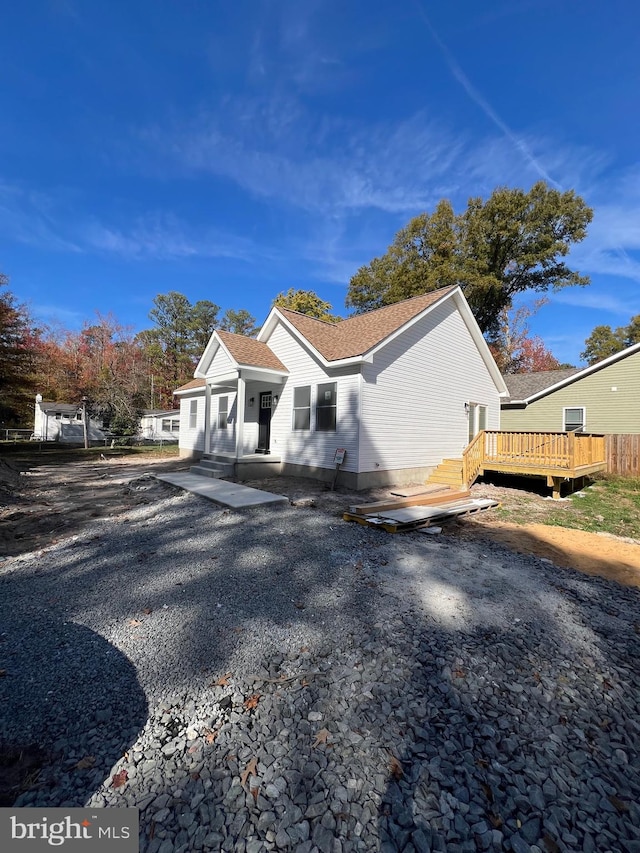 view of side of property featuring a wooden deck