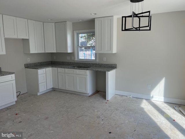 kitchen with white cabinetry and pendant lighting