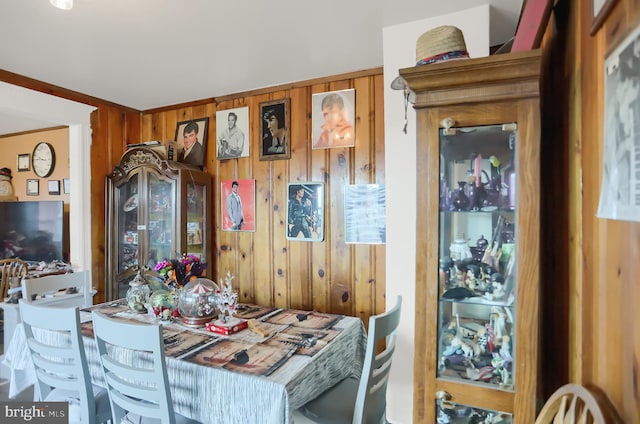 dining room with wooden walls