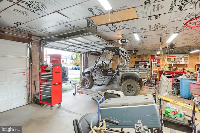 garage featuring a garage door opener and a workshop area