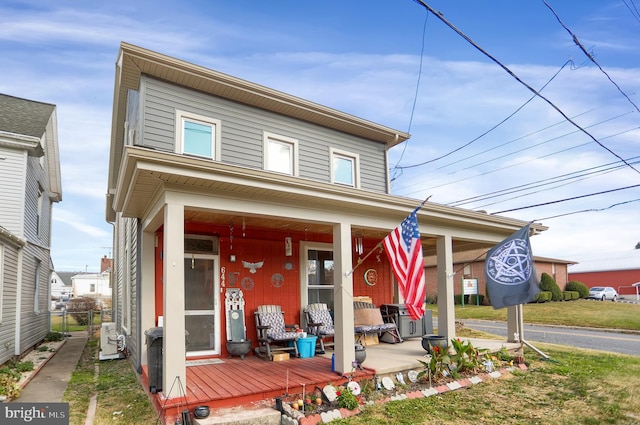 view of front of house with ac unit and covered porch