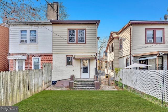 back of property with a lawn and cooling unit