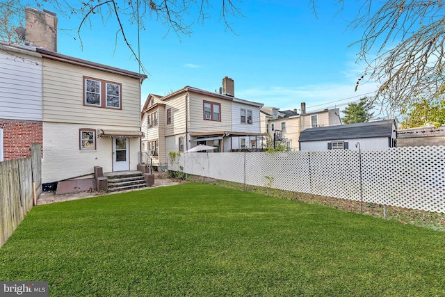 rear view of house with a lawn