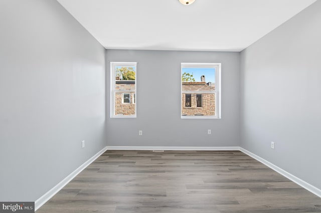 unfurnished room featuring hardwood / wood-style flooring