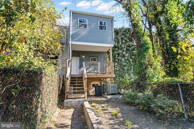 1106 Mckean Ave, Baltimore, MD 21217 - rear view of property with stairway, fence, stucco siding, central AC, and a porch