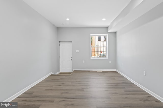 spare room with hardwood / wood-style floors