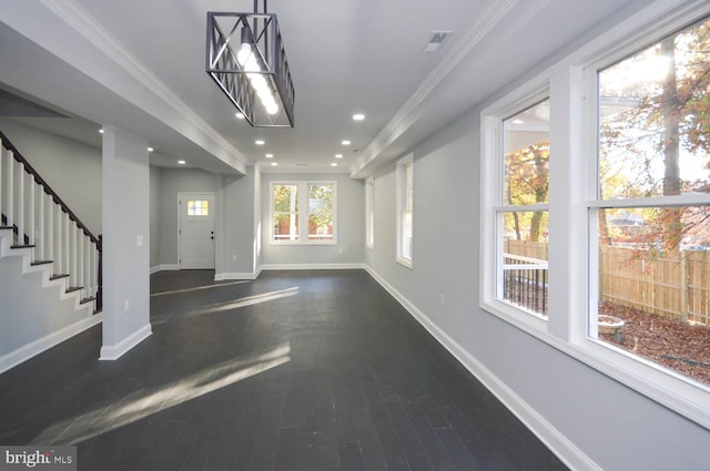 interior space with dark hardwood / wood-style floors and crown molding