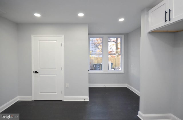 unfurnished room featuring dark wood-type flooring