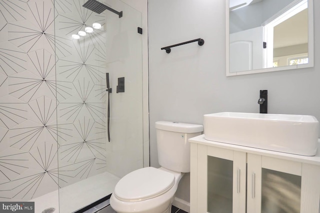 bathroom featuring vanity, toilet, and an enclosed shower