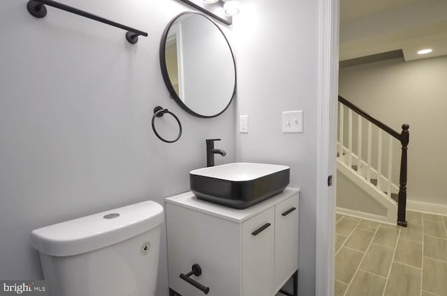 bathroom featuring toilet and vanity