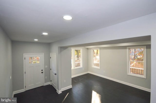 entrance foyer with a healthy amount of sunlight and dark hardwood / wood-style floors