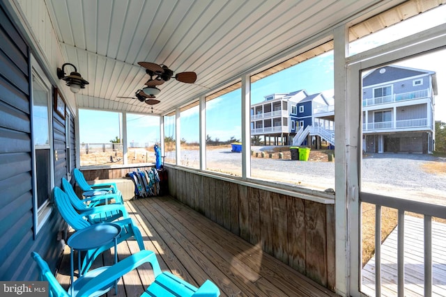 sunroom / solarium featuring ceiling fan and wood ceiling