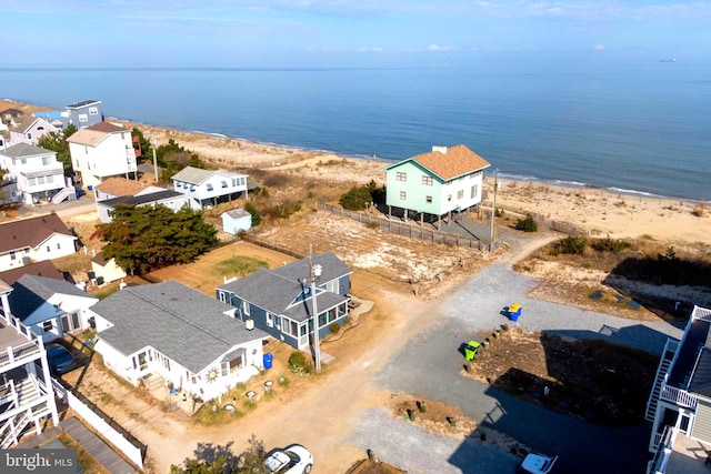 aerial view with a water view and a beach view