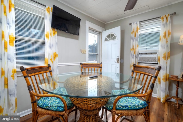 dining room with hardwood / wood-style floors, cooling unit, ceiling fan, and crown molding