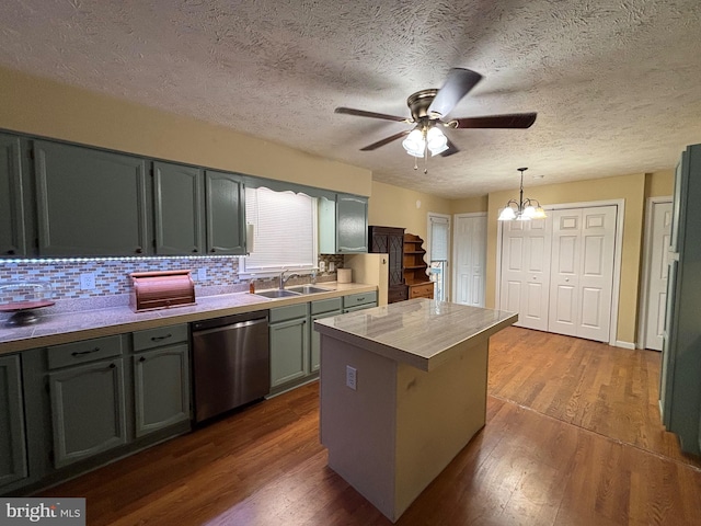 kitchen with dark hardwood / wood-style flooring, backsplash, sink, decorative light fixtures, and dishwasher