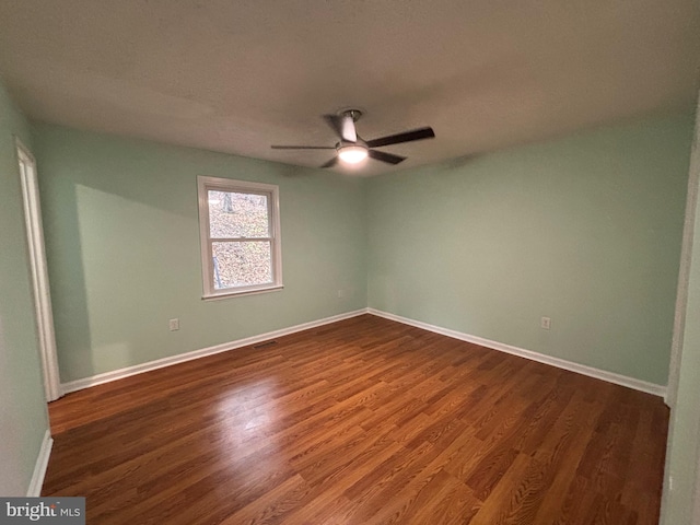 spare room with hardwood / wood-style flooring and ceiling fan