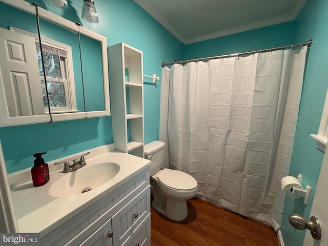 bathroom with walk in shower, vanity, crown molding, hardwood / wood-style flooring, and toilet